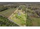 Aerial view of property boundaries, residence, wooded areas, and open land at 1871 Weems Rd, Locust Grove, GA 30248