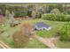 Aerial view showcasing the home, surrounding buildings, landscaping and driveway at 1871 Weems Rd, Locust Grove, GA 30248