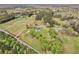 Aerial view of property featuring the house, outbuildings, and wooded acreage at 1871 Weems Rd, Locust Grove, GA 30248