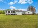 Expansive backyard featuring the white home exterior and abundant green space at 1871 Weems Rd, Locust Grove, GA 30248