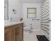 Well-lit bathroom featuring modern fixtures, shiplap accent wall, and a combo tub-shower at 1871 Weems Rd, Locust Grove, GA 30248