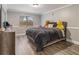 Bedroom with wood-look flooring, grey walls, and a large window offering natural light at 1871 Weems Rd, Locust Grove, GA 30248