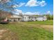 Charming single-story home with a covered porch, white siding, and a spacious front yard at 1871 Weems Rd, Locust Grove, GA 30248