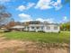 Charming single-story home with a covered porch, white siding, and a spacious front yard at 1871 Weems Rd, Locust Grove, GA 30248