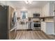 Modern kitchen featuring stainless steel appliances, white cabinets, and stylish backsplash at 1871 Weems Rd, Locust Grove, GA 30248