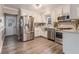 Bright kitchen showcasing stainless steel appliances, white cabinets, and modern flooring at 1871 Weems Rd, Locust Grove, GA 30248
