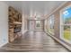 Bright and airy living room featuring hardwood floors, a stone fireplace, and large windows at 1871 Weems Rd, Locust Grove, GA 30248
