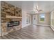 Inviting living room with a stone fireplace, wood-look floors, and neutral walls at 1871 Weems Rd, Locust Grove, GA 30248