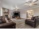 Inviting living room featuring hardwood floors, a stone fireplace, and two leather couches at 1871 Weems Rd, Locust Grove, GA 30248