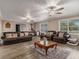 Spacious living room with hardwood floors, lots of seating, and plenty of natural light at 1871 Weems Rd, Locust Grove, GA 30248