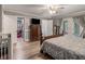 Spacious main bedroom with wood-look floors, a ceiling fan, and a walk-in closet at 1871 Weems Rd, Locust Grove, GA 30248