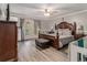 Serene main bedroom featuring a ceiling fan, wood-look floors, and a private balcony at 1871 Weems Rd, Locust Grove, GA 30248
