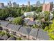 Aerial view showing the property's community pool and surrounding buildings with city skyline in the distance at 3675 Peachtree Ne Rd # 9, Atlanta, GA 30319