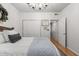 Clean bedroom with a white bedspread, decorative wreath, and organized closets at 3675 Peachtree Ne Rd # 9, Atlanta, GA 30319