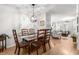 Inviting dining room featuring wood floors and a stylish light fixture that enhances the aesthetic appeal at 3675 Peachtree Ne Rd # 9, Atlanta, GA 30319