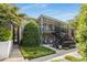 Exterior of a two-story brick building with staircases and balconies, surrounded by lush landscaping at 3675 Peachtree Ne Rd # 9, Atlanta, GA 30319