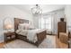 Cozy primary bedroom with hardwood floors, a neutral color palette, and lots of pillows at 3675 Peachtree Ne Rd # 9, Atlanta, GA 30319