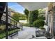 View of a furnished covered patio with brick walls, lush landscaping, and seating area at 3675 Peachtree Ne Rd # 9, Atlanta, GA 30319