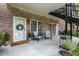 Cozy outdoor patio featuring chairs, table, wreath on door, and landscaped surroundings at 3675 Peachtree Ne Rd # 9, Atlanta, GA 30319