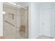 Accessible walk-in shower with glass enclosure and seat, promoting safety and comfort at 3720 Bridle Ridge Dr, Suwanee, GA 30024