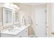 Well-lit bathroom featuring double sinks, white cabinetry, modern fixtures, and fresh, neutral tones at 3720 Bridle Ridge Dr, Suwanee, GA 30024