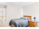 Neutral bedroom with a bed, nightstand, and lamp, offering a serene and inviting personal space at 3720 Bridle Ridge Dr, Suwanee, GA 30024