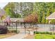 A community pool area with ample seating, surrounded by a black fence with US flag waving at 3720 Bridle Ridge Dr, Suwanee, GA 30024
