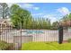 A community pool with plenty of seating surrounded by a black fence at 3720 Bridle Ridge Dr, Suwanee, GA 30024
