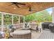 Inviting covered deck with comfortable seating, wood ceiling and outdoor grill for entertaining at 3720 Bridle Ridge Dr, Suwanee, GA 30024