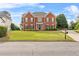 Beautiful red brick home boasts a well-maintained lawn and traditional curb appeal at 3720 Bridle Ridge Dr, Suwanee, GA 30024