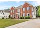 Stunning red brick home with an attached garage and lush green lawn at 3720 Bridle Ridge Dr, Suwanee, GA 30024