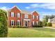 Elegant brick home with black shutters, a well-kept lawn, and mature trees at 3720 Bridle Ridge Dr, Suwanee, GA 30024