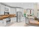Modern kitchen featuring stainless steel appliances, white cabinetry, and granite countertops at 3720 Bridle Ridge Dr, Suwanee, GA 30024