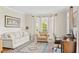 Cozy living room with neutral colors, plush seating, and a large bay window at 3720 Bridle Ridge Dr, Suwanee, GA 30024