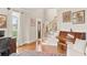 Comfortable living area featuring hardwood floors, a piano, and large windows at 3720 Bridle Ridge Dr, Suwanee, GA 30024