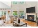 Open-concept living room features fireplace, views to screened porch, and breakfast nook at 3720 Bridle Ridge Dr, Suwanee, GA 30024