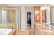 Elegant bathroom with granite counters, dual sinks, soaking tub and walk-in shower at 3720 Bridle Ridge Dr, Suwanee, GA 30024