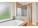 Bright bathroom with soaking tub and a tiled walk-in shower at 3720 Bridle Ridge Dr, Suwanee, GA 30024