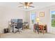 Bright home office with two windows, desk, chair, and ceiling fan providing a functional workspace at 3720 Bridle Ridge Dr, Suwanee, GA 30024