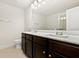 This bathroom has dual sinks, granite countertops, and modern lighting at 11112 Benton Woods Dr, Covington, GA 30014