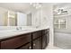 This bathroom has dual sinks, granite countertops, and modern lighting and tile floors at 11112 Benton Woods Dr, Covington, GA 30014