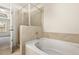 This bathroom has a separate tub and shower and tile flooring at 11112 Benton Woods Dr, Covington, GA 30014