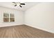 Bright and spacious bedroom featuring wood floors, a window, and neutral decor at 11112 Benton Woods Dr, Covington, GA 30014