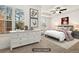This bedroom features a ceiling fan, a neutral carpet, and great natural light at 11112 Benton Woods Dr, Covington, GA 30014