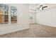The primary bedroom has neutral walls and carpet with ample light and a tray ceiling at 11112 Benton Woods Dr, Covington, GA 30014