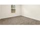 Carpeted bedroom featuring a window with blinds and neutral paint at 11112 Benton Woods Dr, Covington, GA 30014