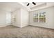 The bedroom has neutral walls and carpet with ample light and a ceiling fan at 11112 Benton Woods Dr, Covington, GA 30014