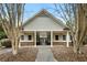 Community clubhouse featuring gray siding, brick base, and covered entryway at 11112 Benton Woods Dr, Covington, GA 30014