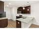 Well-lit kitchen featuring granite countertops, stainless steel appliances, and dark wood cabinets at 11112 Benton Woods Dr, Covington, GA 30014