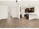 Open-concept living area with wood floors and views to the kitchen at 11112 Benton Woods Dr, Covington, GA 30014
